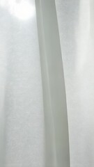 Poster - Soft sunlight filtering through billowing white satin finish, White background curtain, casting ethereal glow near window gauze gentle breeze with video