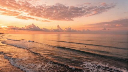 Poster - Serene sunset over calm ocean waves with colorful clouds.