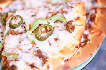 Poster - A delicious-looking pizza with various toppings and sauce, served on a white plate.