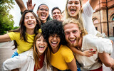 Multicultural group of young people smiling at camera outdoors - Happy friends having fun on city street - Youth community with diverse guys and girls hugging together