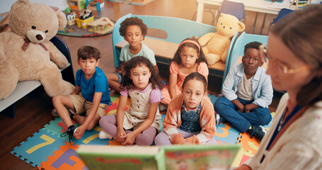 Aufkleber - Reading book, classroom and children listening to teacher for lesson, education and learning. Preschool, students and kids on floor with educator for storytelling, language development and knowledge
