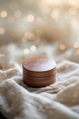 Poster - Crafted wooden box on soft fabric with shimmering bokeh lights in the background during a cozy indoor setting