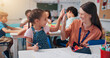 © peopleimages.com - Education, teacher and high five girl in classroom for lesson support, creative activity and learning progress. People, educator and student with fine motor skills success and knowledge development