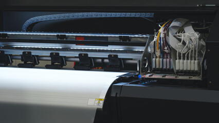 Poster - A printer is open and has a white sheet of paper inside. The printer is black and has a yellow and red color