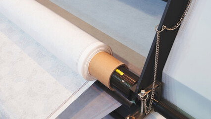Poster - A roll of paper is being fed through a industrial printer machine. The roll is white and the machine is black