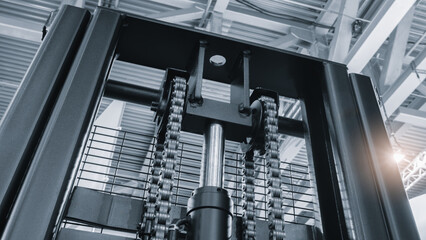Poster - A black machine with a chain and a bolt. The bolt is silver