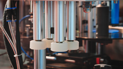 Poster - Fragment of the conveyor of sticking labeling machine for packaging food products or pharmaceuticals. Abstract industrial background.
