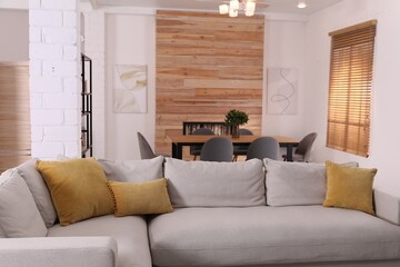 Poster - Comfortable sofa and wooden table in living room. Interior design