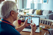 © Davor - Senior man having video call with doctor from home