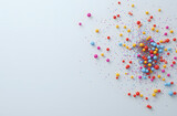 Colorful sprinkles falling on a white background