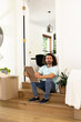 © Wavebreak Media - Young man sitting on steps holding picture frame, contemplating in new home