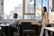 © PintoArt - Businesspeople working in modern office with city view