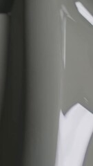 Poster - Smooth transition of light over curved modern surface highlighting reflection dynamics