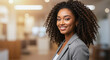 © Gamusino - Young Black Businesswoman with Curly Hair: Professional Portrait. Copy Space