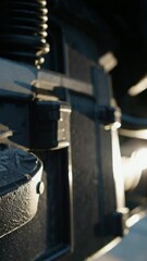 Poster - Metallic machinery components in motion with sunlight reflections and engineering details
