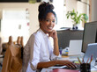 © Wavebreak Media - Confident woman working on laptop at office, smiling and looking at camera