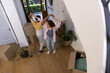© Wavebreak Media - Young diverse couple dancing joyfully in new home surrounded by moving boxes
