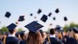© Andrei - joyful group of graduates in caps and gowns tossing hats in vibrant celebration against clear blue sky vivid backdrop