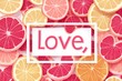 © Юлія Ткачук - The word love is written on a background of cut fruit.