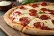 © Роман Заворотный - Hot Pepperoni Pizza on Wooden Board With Fresh Herbs Generative AI