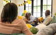 © Wavebreak Media - Birthday celebration with diverse senior friends, surrounded by balloons, at home