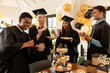 © Wavebreak Media - Diverse graduates celebrating with snacks and drinks at home, enjoying their success