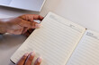 © Wavebreak Media - Close-up of hands holding open notebook, ready for writing notes at office, copy space