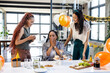 © Wavebreak Media - Celebrating birthday at office, diverse women enjoying cake and laughter together
