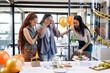 © Wavebreak Media - Diverse female colleagues celebrating birthday with cupcakes and gifts in modern office