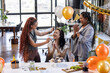 © Wavebreak Media - Female diverse colleagues celebrating birthday in office with cake and balloons, smiling joyfully