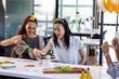 © Wavebreak Media - Female diverse colleagues celebrating at office with cupcakes and party hats, enjoying festivities