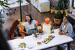 © Wavebreak Media - Female diverse colleagues celebrating at office with gifts, balloons, and snacks, sharing laughter