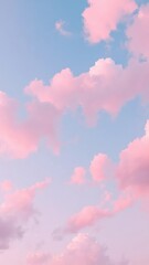 Wall Mural - Clouds in shades of pink and blue float across a clear sky, soft, clouds