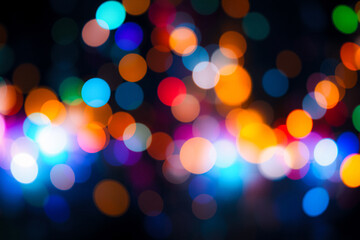 Poster - Softly blurred lights create a beautiful bokeh effect against a dark night sky.  Colorful circles of light in shades of orange, red, blue, green, and purple shine brightly.