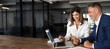 © Stock 4 You - Mature Latin business man mentoring mid age European business woman discussing project on laptop in office. Two colleagues, group of partners, businessman and businesswoman working. Banner, copy space