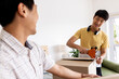© Wavebreak Media - Father and son packing cardboard boxes together, smiling and enjoying teamwork, at home