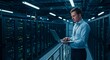 © ekalaila - Man works on a laptop in a modern data center environment