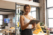 © Wavebreak Media - Smiling woman using tablet in modern office, embracing digital technology