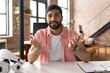 © Wavebreak Media - Smiling man in casual shirt explaining ideas at modern office desk