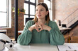© Wavebreak Media - Businesswoman in green blouse contemplating ideas at modern office desk