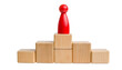 © photostockatinat - a red figure on top of a wooden podium, symbolizing success and achievement. The figure stands out prominently