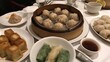 © Pannin - A spread of dim sum including dumplings, buns, and spring rolls.