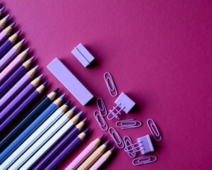 Poster - Purple pencils, erasers, and paper clips arranged on a purple background, creating a vibrant and organized stationery scene, showcasing creativity and organization