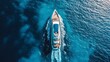 © Karo - Aerial view of a luxury yacht captured in a bright turquoise water in ocean.