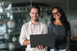 © Dorde - Confident Business Professionals Collaborating with Laptop in a Contemporary Office Setting