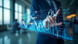 © HaJung - Abstract virtual financial graph hologram displayed on a blurry modern office building background representing forex investment concept with multiexposure concept as Abstract virtual financial graph h