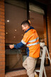 © Austockphoto - Tradie replacing screen of home window