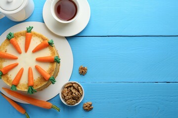 Wall Mural - delicious homemade carrot cake served on light blue wooden table, flat lay. space for text