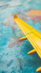 Poster - Close-up of yellow airplane wing on blurred world map background, symbolizing travel, adventure, and exploration, ideal for tourism or journey concepts