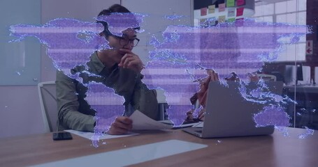 Poster - World map animation over thoughtful person working with laptop and documents